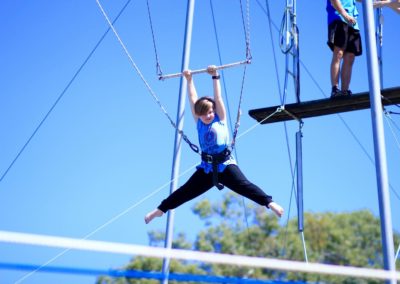 Child on the flying trapeze school holiday program