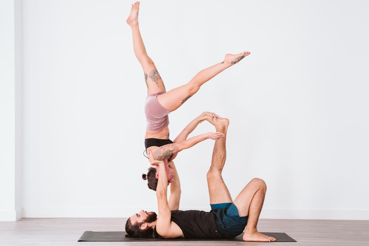Young couple doing acro yoga. Acro yoga concept. Pair yoga. Yoga  flexibility class workout 29888750 Vector Art at Vecteezy